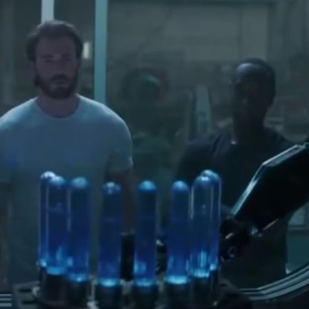 Chris Evans and Don Cheadle are looking at some machine.